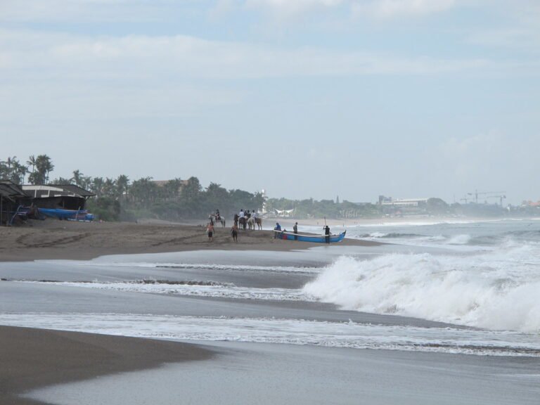 Fishing boat and waves at Pantai Nelayan, Bali