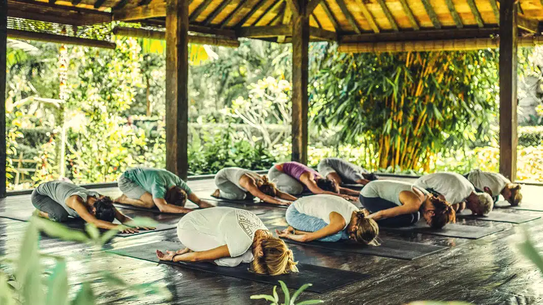 A yoga class in a tranquil, open-air pavilion at Desa Seni A Village Resort