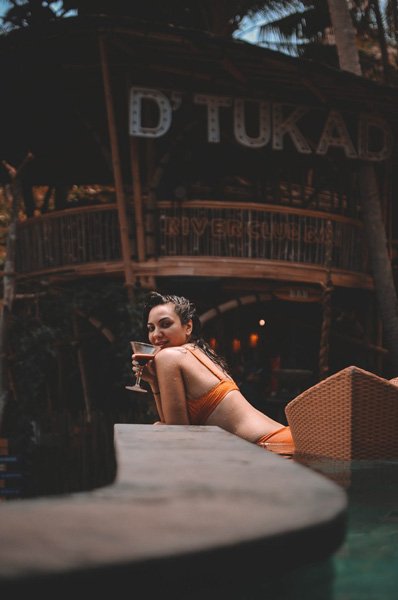 Poolside at D’Tukad River Club Blangsinga with the venue sign in the background